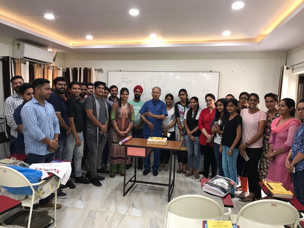 Students are celebrating the birthday of their teacher at Expert judicial Academy Premises